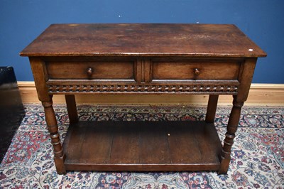 Lot 2644 - A reproduction oak hall table with two frieze...