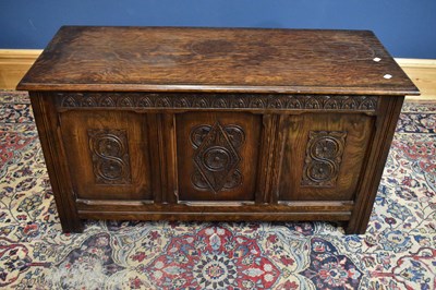 Lot 2399 - An oak coffer with hinged lid above three...