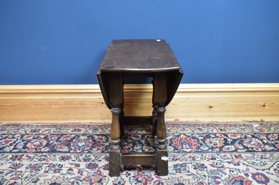 Lot 2659 - A reproduction oak drop leaf coffee table on...