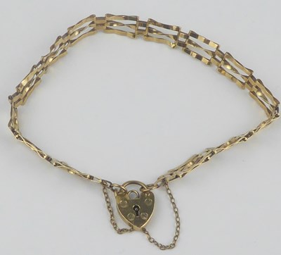 Lot 851 - A 9ct gold three bar dainty gate bracelet...