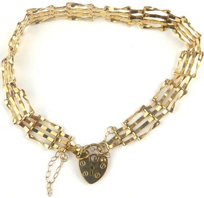 Lot 850 - A 9ct gold four bar gate bracelet united with...