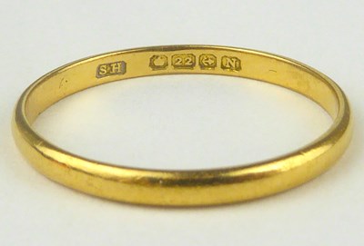 Lot 816 - A 22ct gold thin band ring, size R, approx....