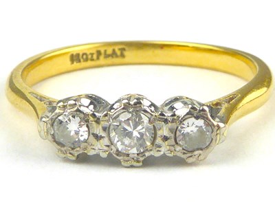 Lot 826 - An 18ct gold three-stone diamond ring, the...