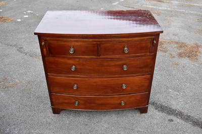 Lot 2503 - A mahogany bowfront chest of two short and...