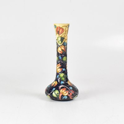 Lot 455 - MOORCROFT; a boxed onion shaped vase, tube...