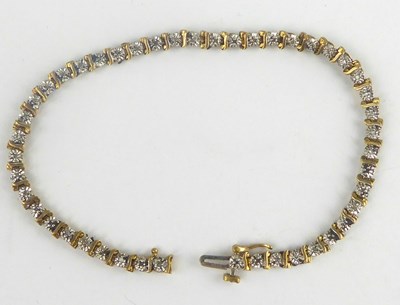 Lot 849 - A 9ct gold diamond tennis bracelet with...