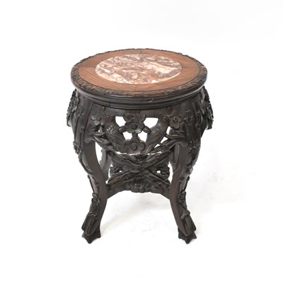 Lot 597 - A Chinese carved hardwood jardinière stand,...