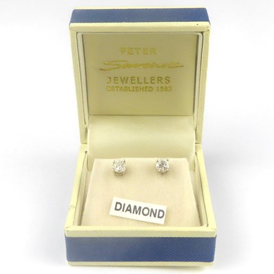 Lot 867 - A pair of 14ct white gold and diamond stud...