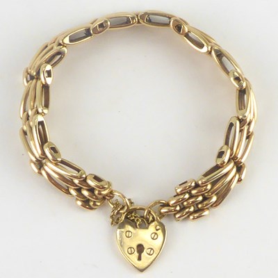 Lot 848 - A 9ct gold three bar gate bracelet with a 9ct...