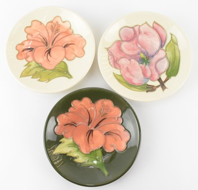 Lot 462 - WALTER MOORCROFT; three tube lined floral pin...