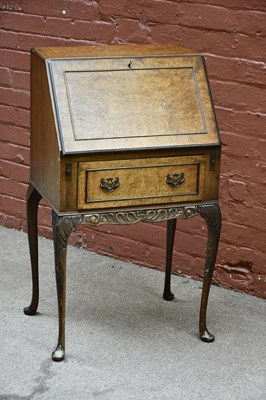 Lot 2664 - A small walnut bureau, the fall front above...
