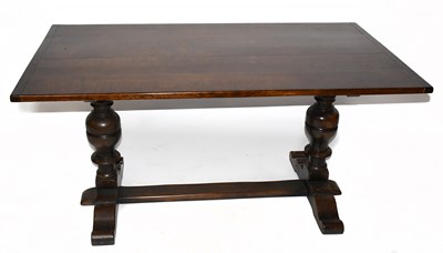 Lot 1736 - A 1950s oak refectory dining table on carved...