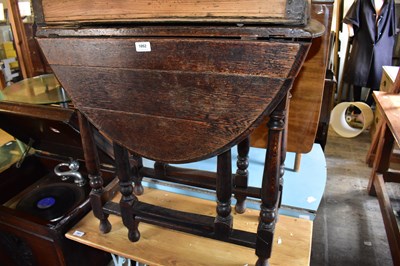 Lot 1052 - A 19th century oak drop-leaf gateleg dining...