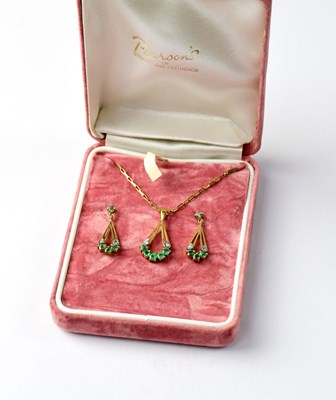 Lot 980 - A 9ct gold double green and white stone floral bouquet pendant