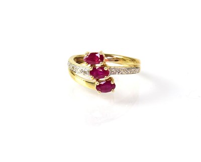 Lot 902 - A yellow metal ring set with three oval rubies...