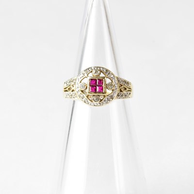 Lot 901 - A yellow metal ring set with four small rubies...