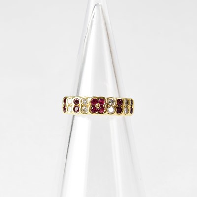 Lot 834 - An 18ct gold ring set with alternating rubies...