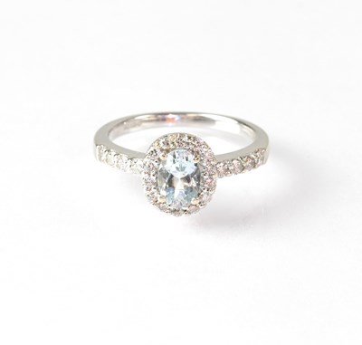 Lot 837 - An 18ct white gold ring set with central pale...