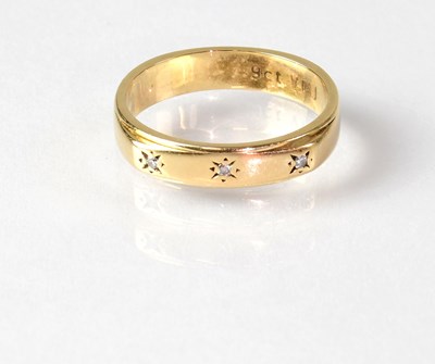 Lot 888 - A 9ct gold wedding band set with three diamond...