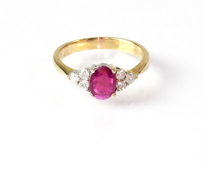 Lot 864 - A 9ct gold ring set with central red stone,...