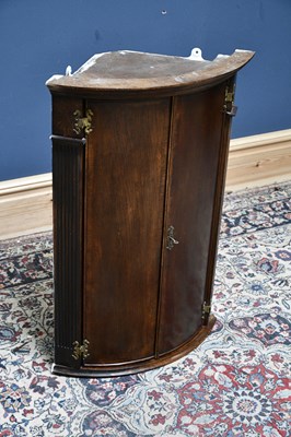 Lot 2666 - A reproduction oak hanging corner cupboard,...