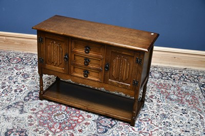 Lot 2629 - A reproduction oak side cabinet with three...