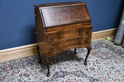 Lot 2567 - A 1950s walnut bureau, the fall front...