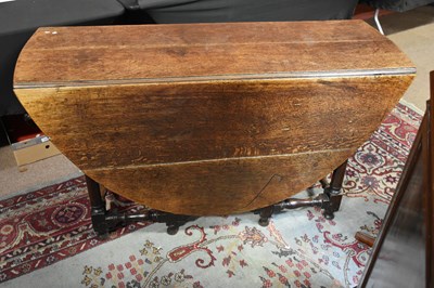 Lot 6536 - A 19th century oak oval drop-leaf dining table...