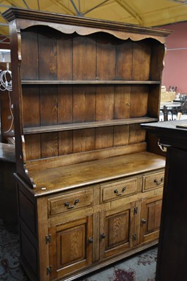 Lot 6719 - A reproduction oak dresser with boarded plate...
