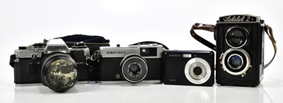 Lot 1567 - A group of four cameras, including Olympus...