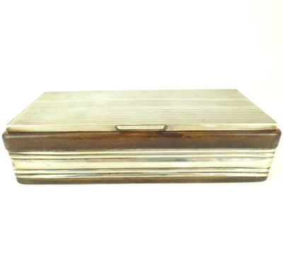 Lot 672 - A Continental hallmarked silver and wood desktop cigarette box