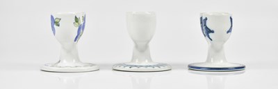 Lot 32 - TROIKA POTTERY; three double egg cups, to...