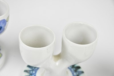 Lot 32 - TROIKA POTTERY; three double egg cups, to...