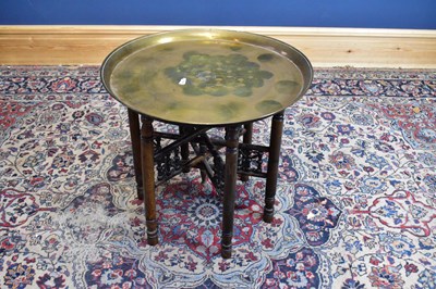 Lot 2558 - An Indian brass topped folding Benares table,...