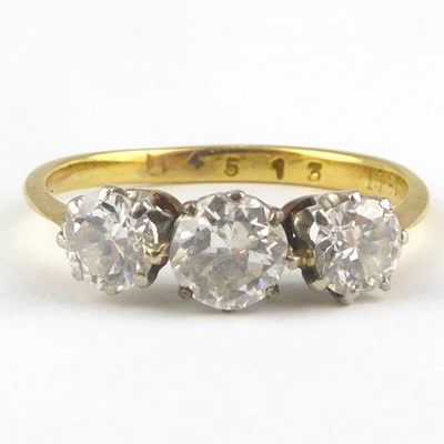 Lot 826 - An 18ct gold three-stone diamond ring with...