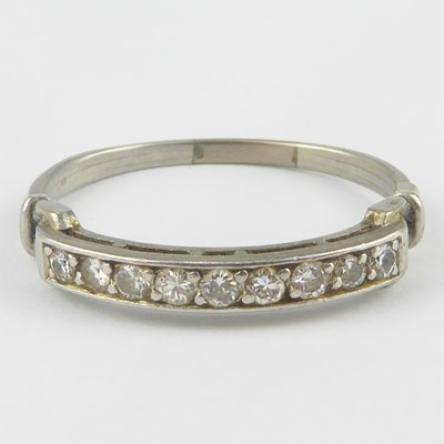 Lot 897 - A white gold and diamond half eternity ring,...