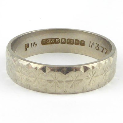 Lot 811 - An 18ct white gold band ring with star pattern,...