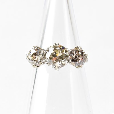 Lot 802 - A platinum three-stone diamond ring, the...