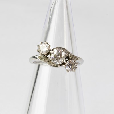 Lot 692 - An 18ct white gold three-stone diamond ring,...