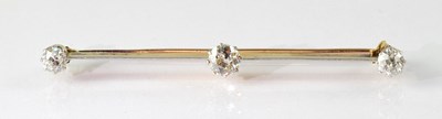 Lot 928 - A yellow metal bar brooch set with three...
