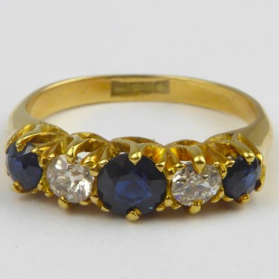 Lot 829 - An 18ct gold diamond and sapphire ring, the...