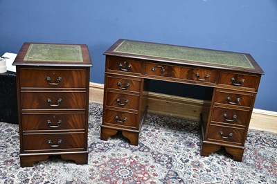 Lot 2630 - A green leather topped pedestal desk, with...