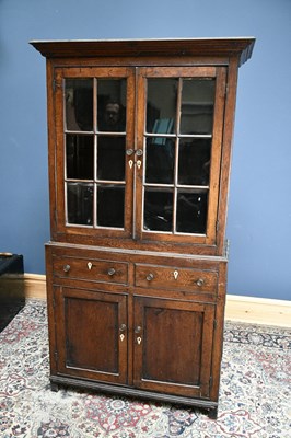 Lot 2429 - An 18th century oak bookcase, the top section...