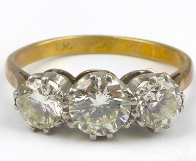 Lot 830 - An 18ct gold three-stone diamond ring, the...