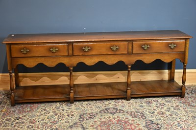 Lot 6510 - A mid-20th century oak three drawer sideboard,...