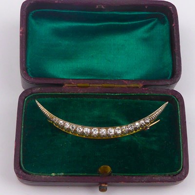 Lot 929 - A vintage diamond crescent brooch, comprising...