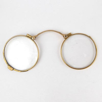Lot 991 - A pair of 9ct gold collapsible spectacles.