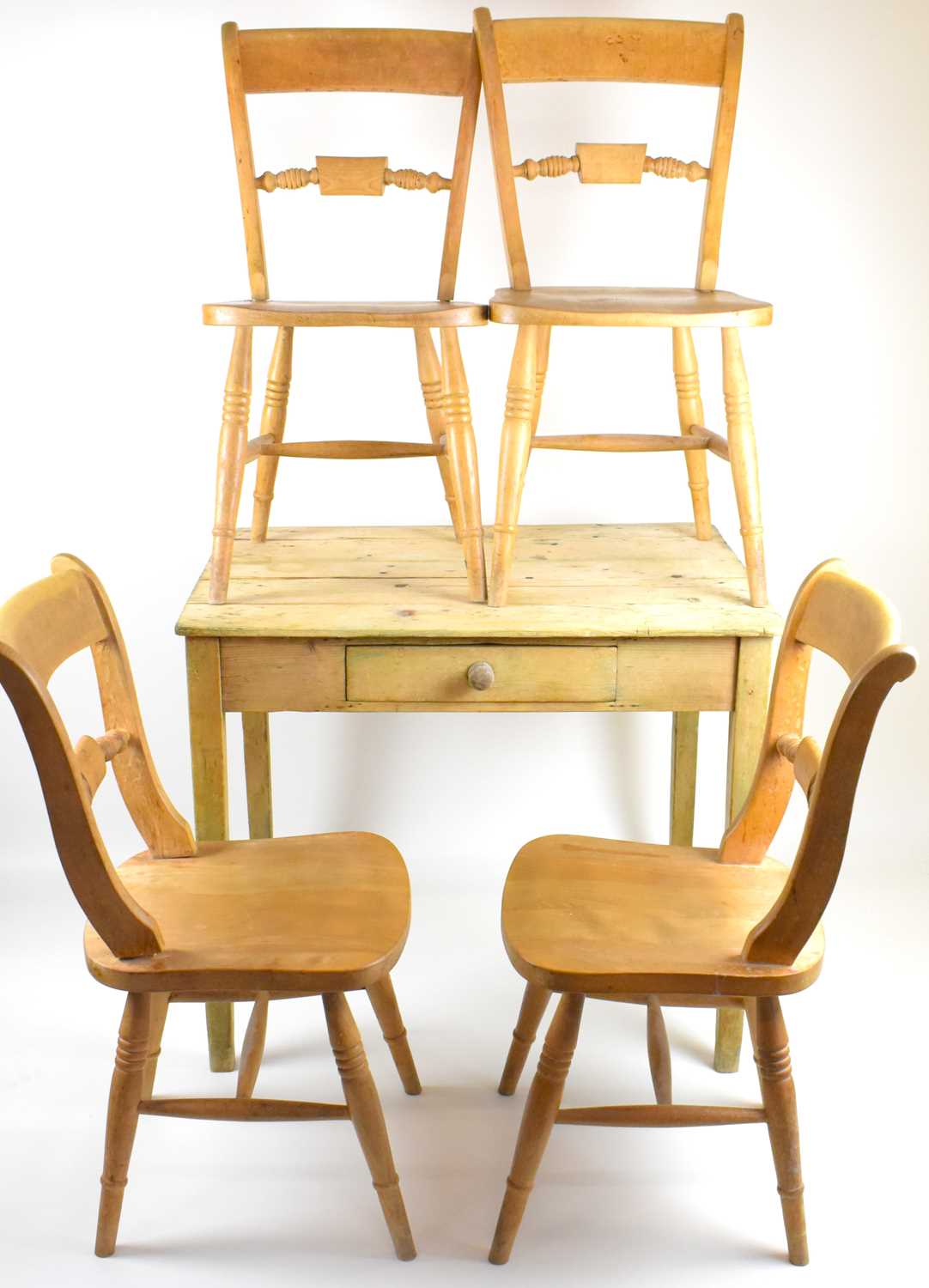 Lot 22 - A small rustic pine kitchen table with single...