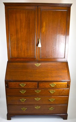 Lot 32 - A George III oak bureau bookcase, the two-door...