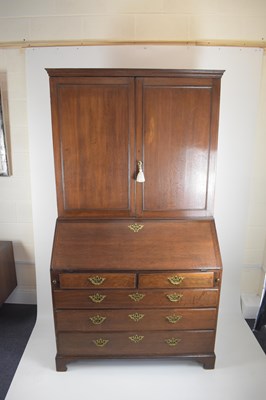 Lot 32 - A George III oak bureau bookcase, the two-door...